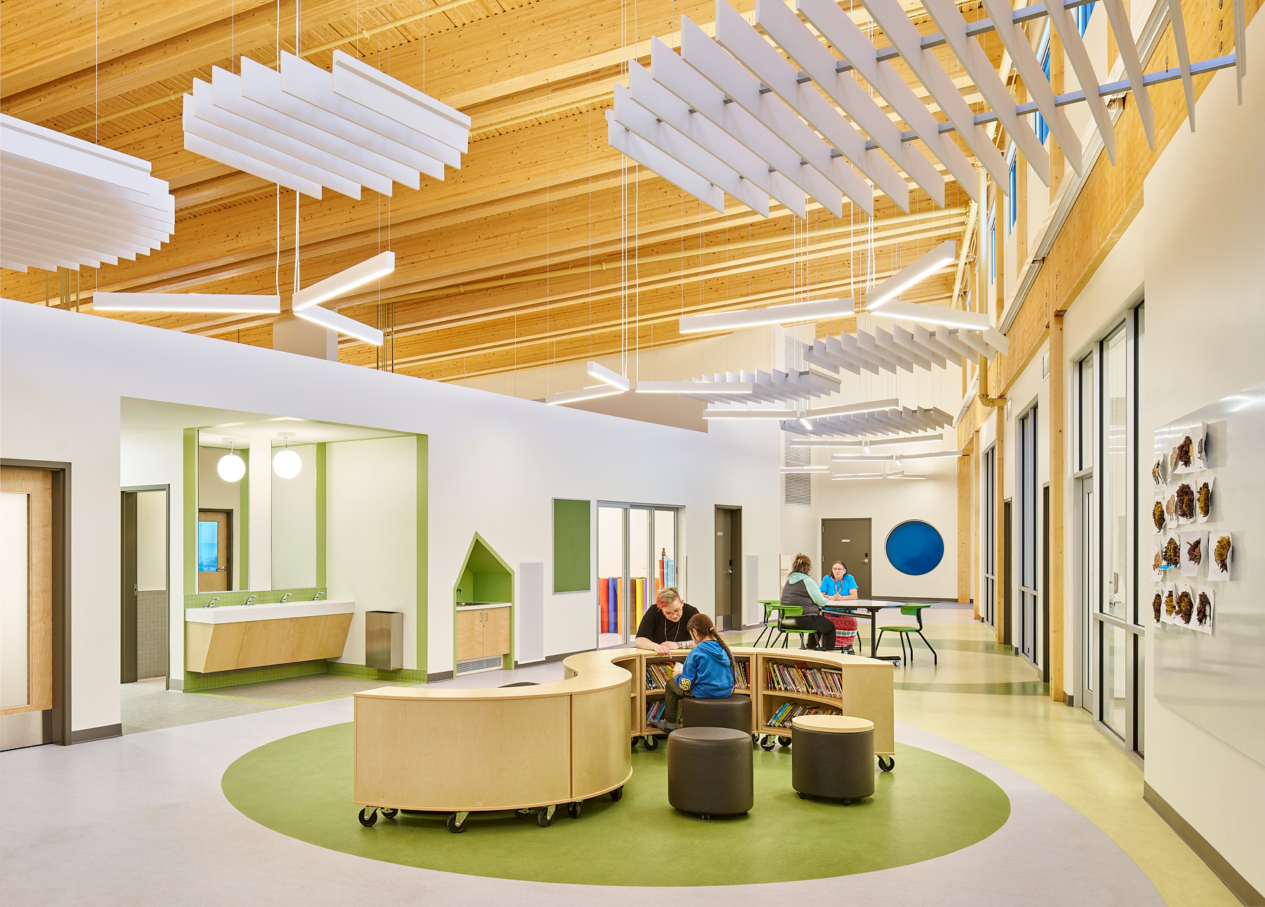 Timber-framed learning commons interior at Saddle Lake Onchaminahos Elementary School